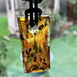 Very unique, reversible glass pendant.